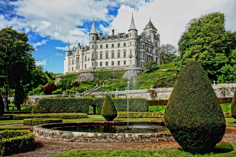 a large castle sitting on top of a lush green hillside, an album cover, by John Murdoch, pexels contest winner, gardens and fountains, white, paisley, opalescent palace