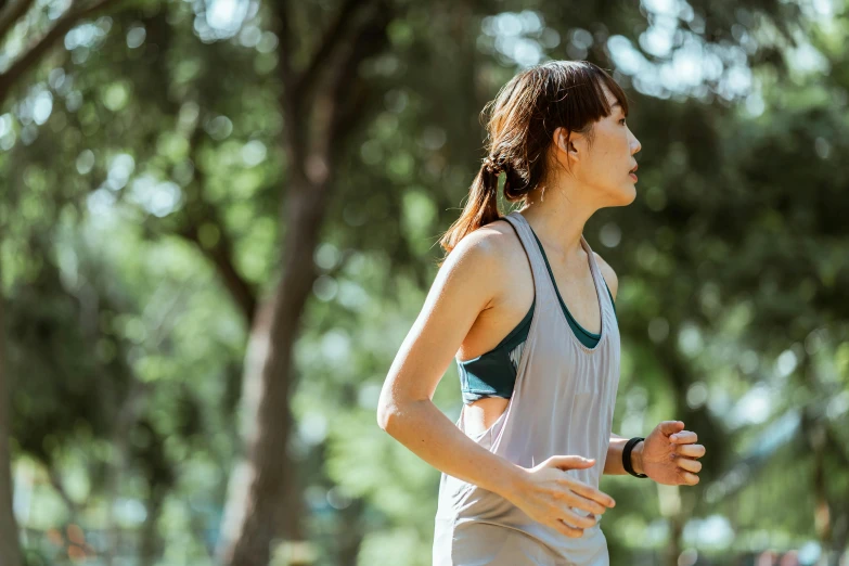 a woman running in a park with trees in the background, pexels contest winner, happening, sweating, asian female, thumbnail, feature