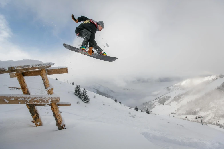 a man flying through the air while riding a snowboard, by Matthias Stom, pexels contest winner, figuration libre, bench, avatar image