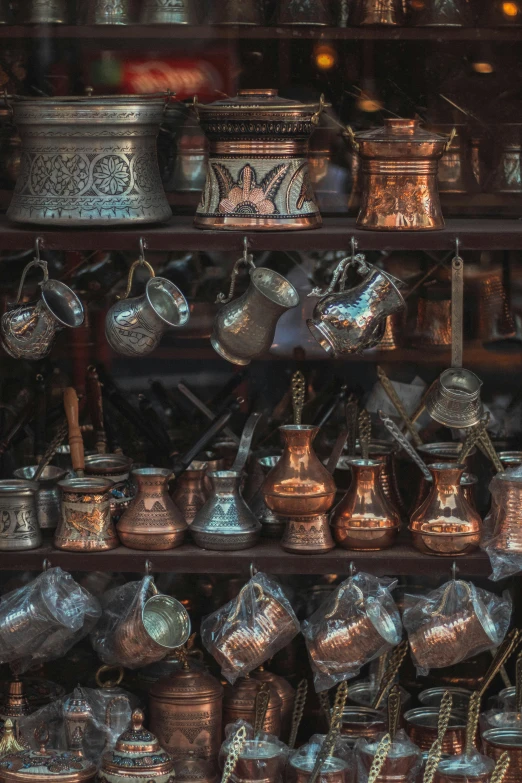 a shelf filled with lots of pots and pans, trending on unsplash, cloisonnism, inside an arabian market bazaar, copper pipers, ancient coffee machine, paul barson