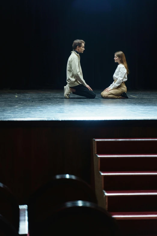 a couple of people sitting on top of a stage, inspired by Peter Brook, unsplash, renaissance, facing each other, b - roll, alexey gurylev, [ theatrical ]