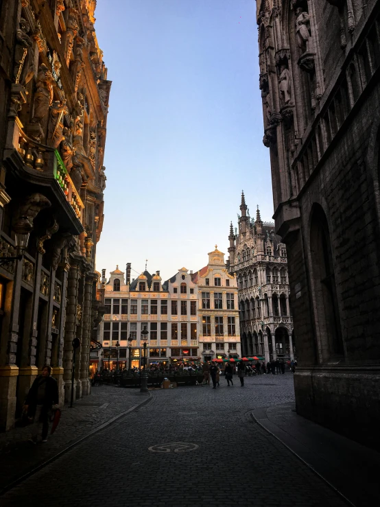 a group of people walking down a street next to tall buildings, renaissance, brussels, beautifully lit buildings, slide show, shining gold and black and red