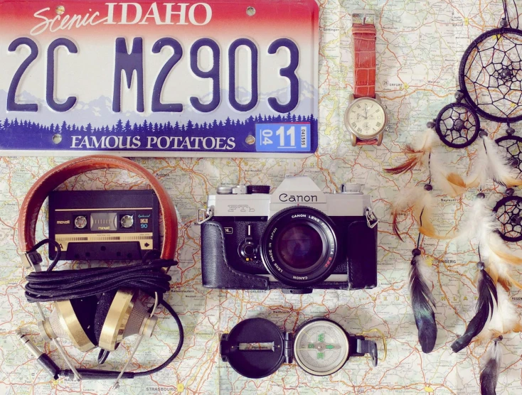 a number of items laid out on a map, a picture, tumblr, idaho, 8 0 s camera, profile image, driving