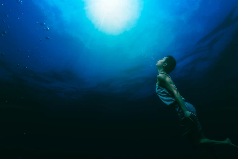 a man in a tank top swimming under water, an album cover, unsplash contest winner, happening, moonlight, ignant, queen of the sea mu yanling, [bioluminescense