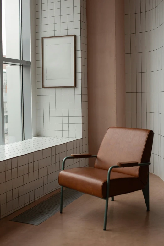 a chair sitting next to a window in a room, inspired by Constantin Hansen, bauhaus, tiled, caramel, leather, photo for a store