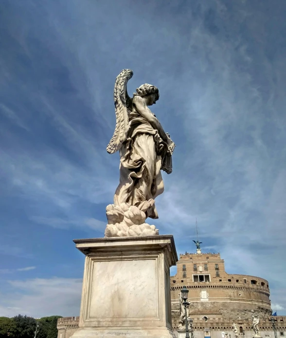 a statue of an angel in front of a castle, by Cagnaccio di San Pietro, pexels contest winner, neoclassicism, standing on a bridge, biblically accurate angels, looking towards the horizon, looking threatening