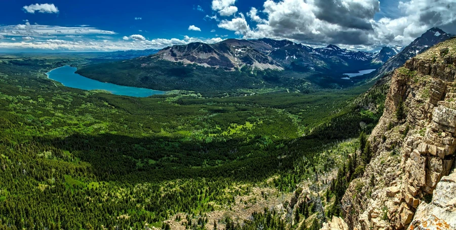 a view of a lake and mountains from the top of a mountain, by Jim Nelson, pexels contest winner, 4k panoramic, evergreen valley, bird\'s eye view, glacier national park