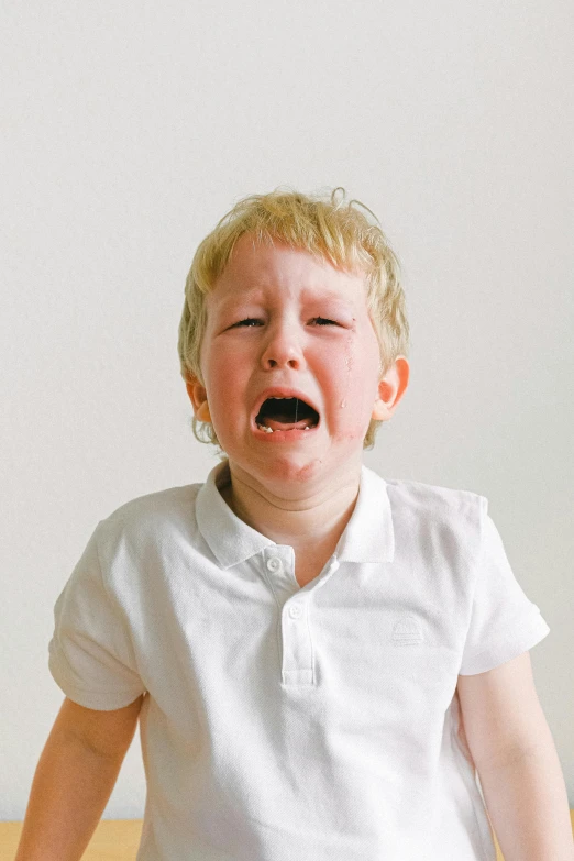 a little boy that is sitting on a bed, screaming and crying, sweaty face, promo image, cavities