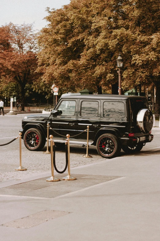 a black suv parked on the side of a road, pexels contest winner, baroque, paris hotel style, black and gold wires, square, panzer