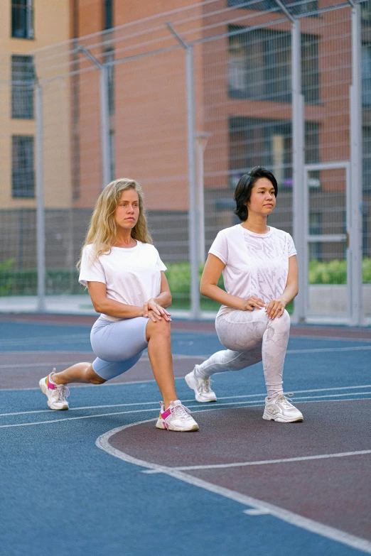 a couple of women sitting on top of a tennis court, an album cover, dribble, dynamic stretching, 1 9 8 9, full body image, half - body composition