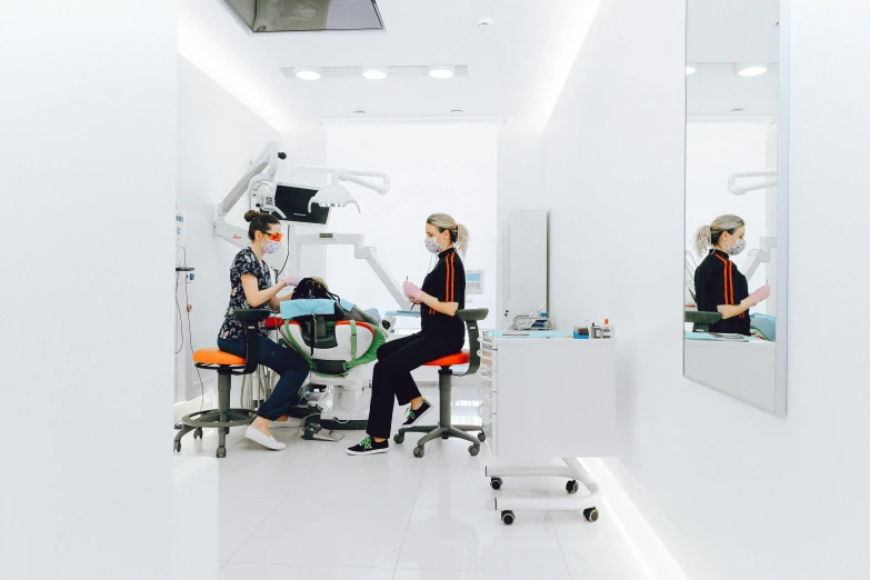 a woman sitting in a chair in front of a mirror, dentist, neo kyiv, profile image