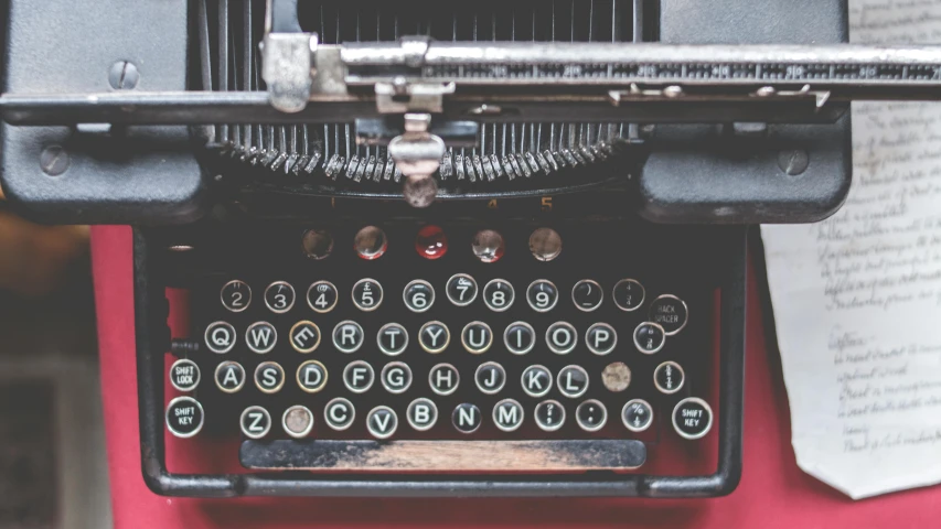 an old typewriter sitting on top of a table, by Carey Morris, trending on unsplash, fan favorite, top down photo, closeup portrait shot, multiple stories