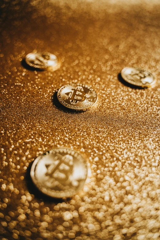 a close up of some coins on a table, a digital rendering, by Julia Pishtar, trending on pexels, unrefined sparkling gold nugget, bitcoin, thumbnail, gold embroidery