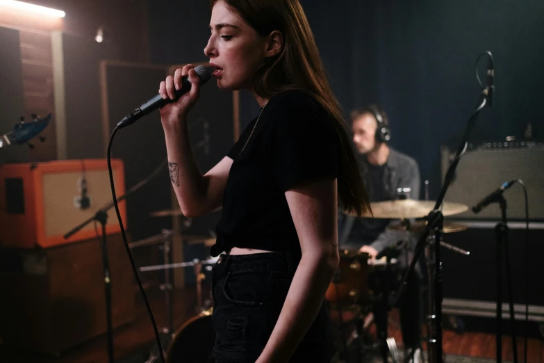 a woman that is standing in front of a microphone, an album cover, pexels contest winner, band playing, charli bowater and artgeem, studio room, 15081959 21121991 01012000 4k