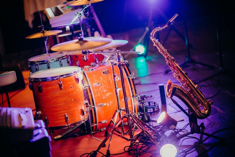 a close up of a musical instrument on a stage, by Joe Bowler, shutterstock, drum kit, coloured, 3 jazz musicians, a wide shot