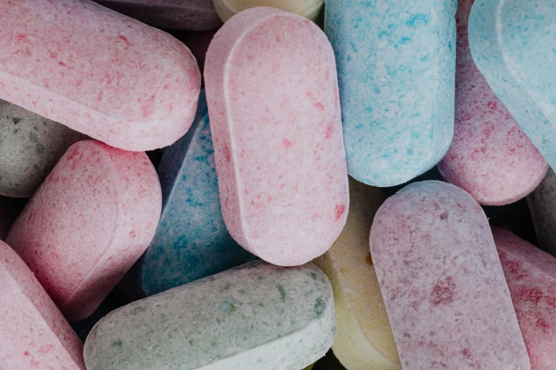 a bunch of pills sitting on top of each other, by Charlotte Harding, pexels, process art, candy pastel, chalk, medium detail, detailed product image