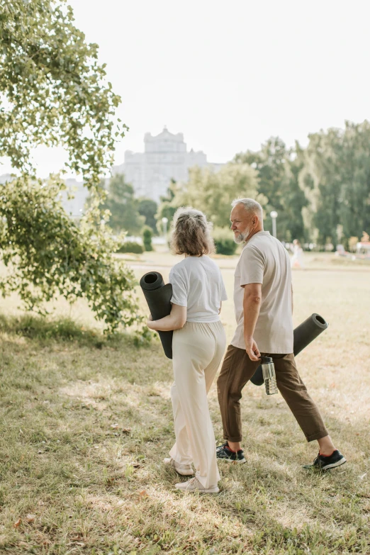 a man and a woman walking in a park, carrying survival gear, old man, profile image, balance