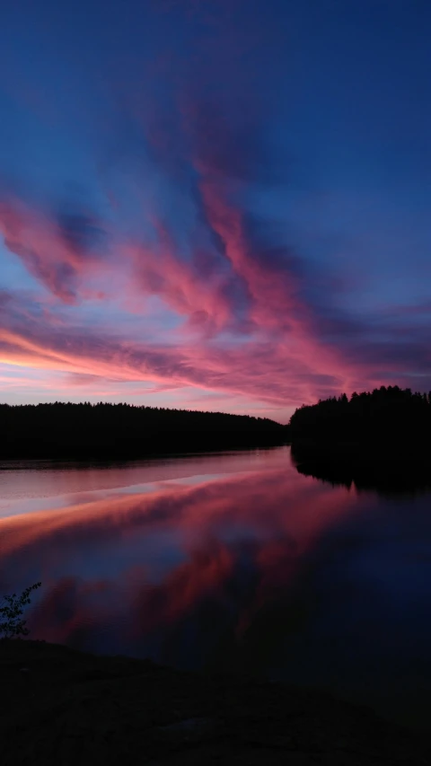 a large body of water next to a forest, by Anato Finnstark, pexels contest winner, hurufiyya, pink clouds in the sky, thumbnail, kirsi salonen, red sky blue