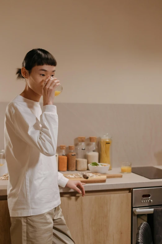 a man standing in a kitchen next to a washing machine, inspired by Gong Kai, unsplash, hyperrealism, woman drinking coffee, wearing wheat yellow gauze, long sleeves, skincare