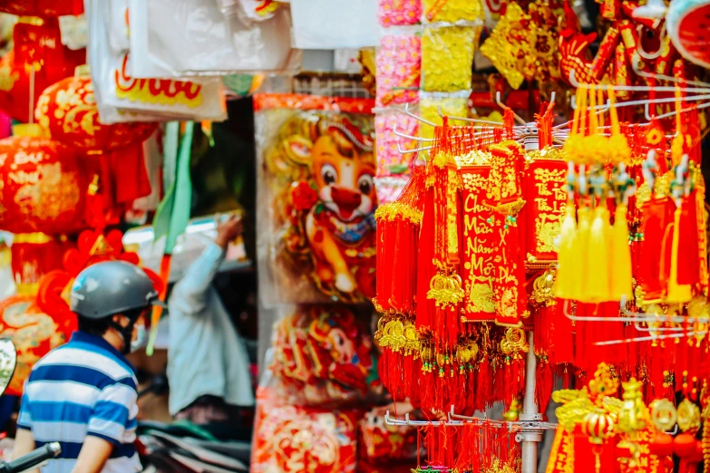 a man riding a scooter in front of a store, pexels contest winner, cloisonnism, red banners, yellow lanterns, colorful adornments, chinatown