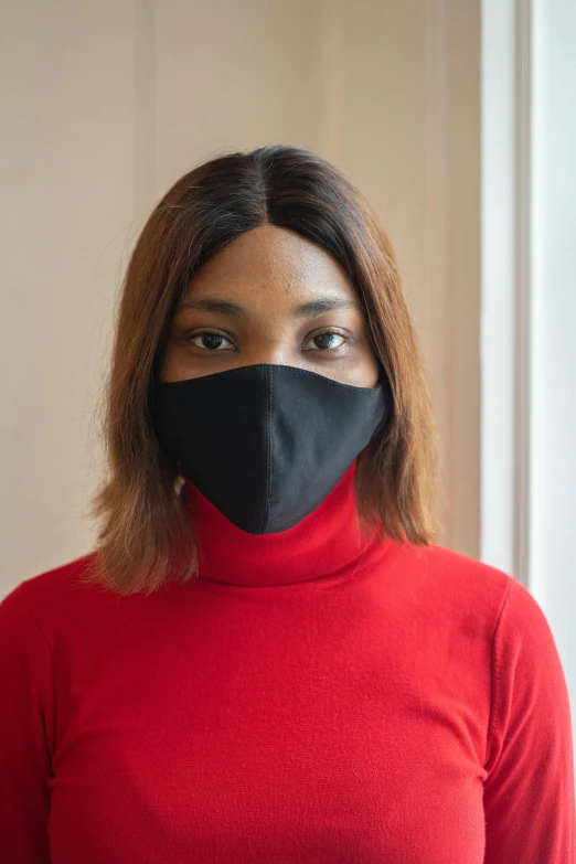 a woman wearing a black face mask, by Nina Hamnett, rectangle, mkbhd, slightly red, portrait mode