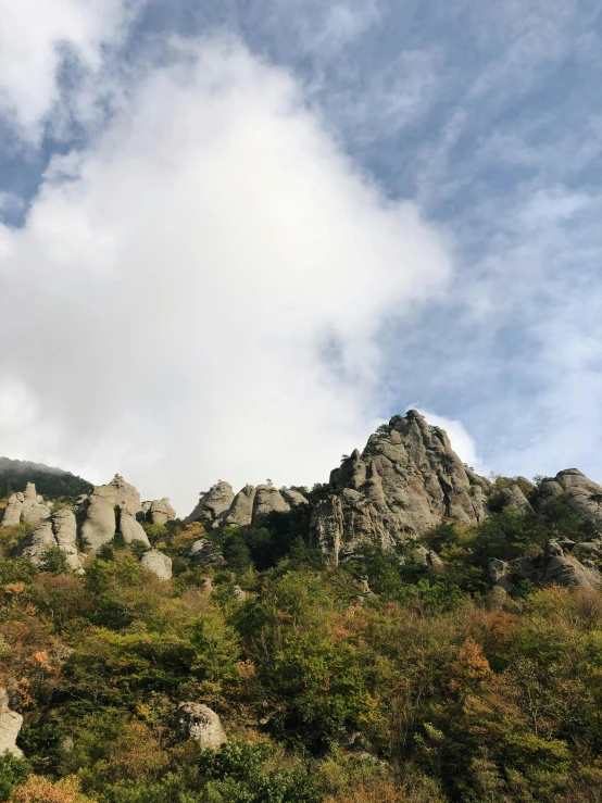 a group of people standing on top of a mountain, a picture, inspired by Saneatsu Mushanokōji, bright white castle stones, nice slight overcast weather, photo on iphone, low angle 8k hd nature photo