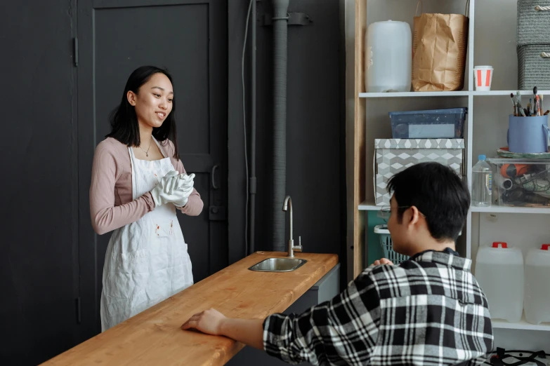 a woman standing next to a boy in a kitchen, by Jang Seung-eop, pexels contest winner, interactive art, aussie baristas, holding hand, background image, serving suggestion