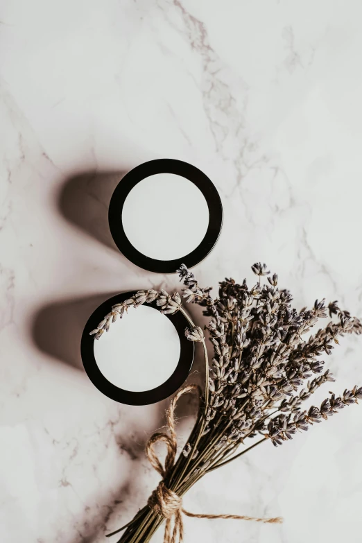 a couple of jars sitting on top of a table, trending on pexels, skin texture natural, product view, white and black, lavender