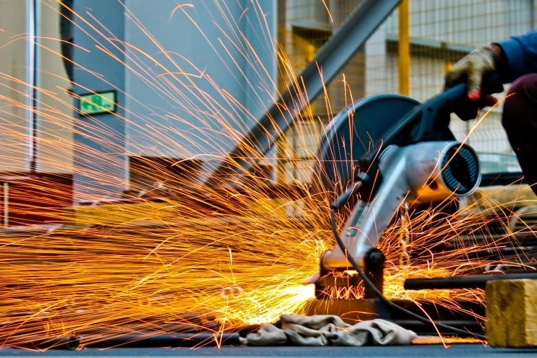 a welder working on a piece of metal, by Matt Stewart, pexels contest winner, complex background, avatar image, grind, full colour