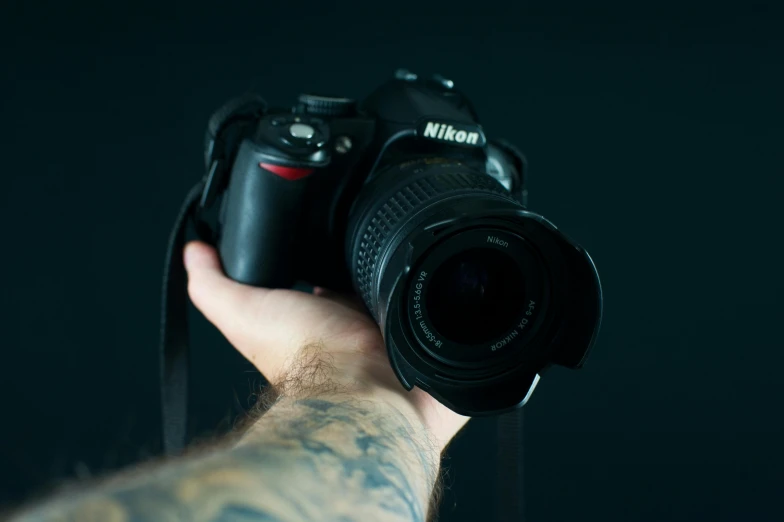 a person holding a camera in their hand, nikon d 8 0 7, hasselblade shot, portait image