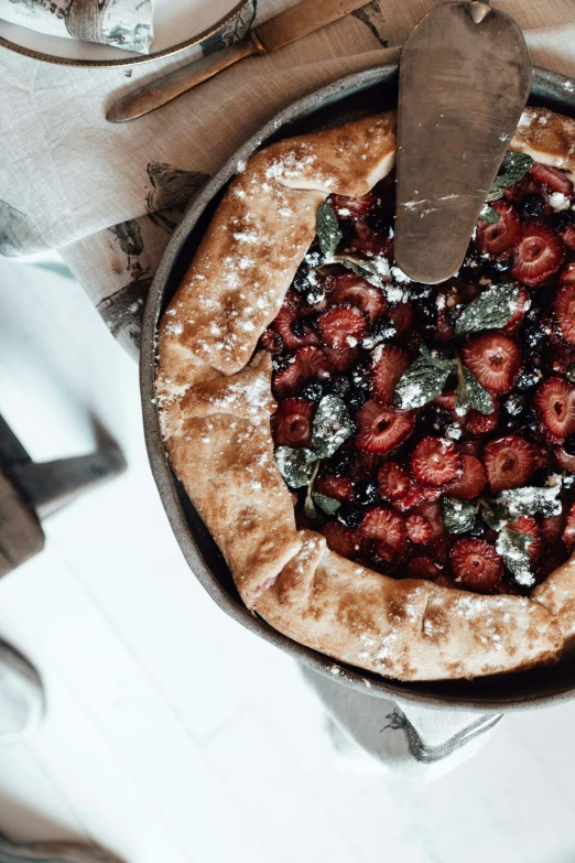 a pie sitting on top of a pan on top of a table, trending on unsplash, hurufiyya, berries inside structure, romantic lead, colorful”, basil gogos