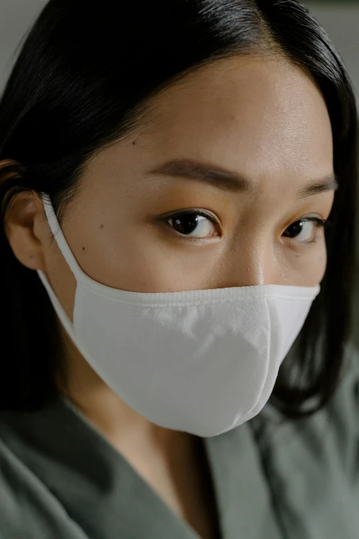 a close up of a person wearing a face mask, wearing a white shirt, asian face, soft shade, beige