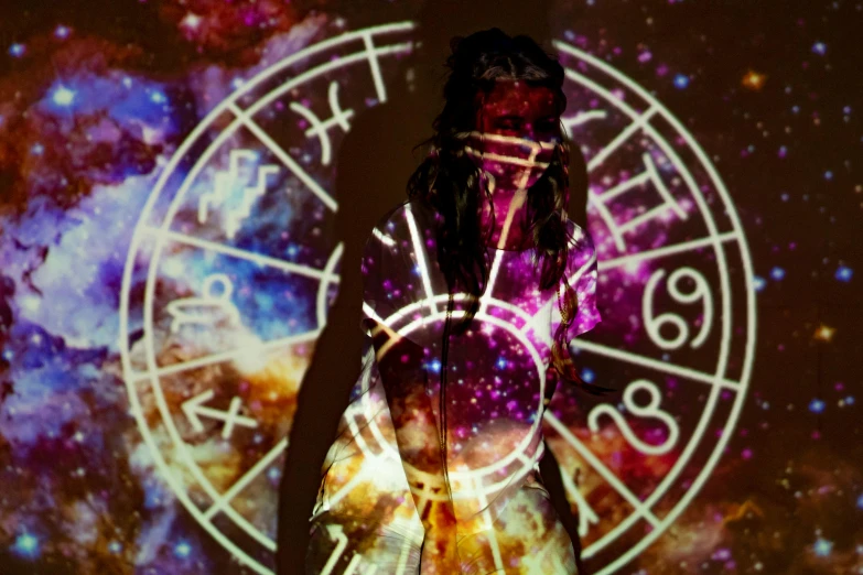 a woman that is standing in front of a clock, a hologram, by Julia Pishtar, trending on pexels, wearing psychedelic wicca, covered in runes, 3 6 0 projection, zodiac sign