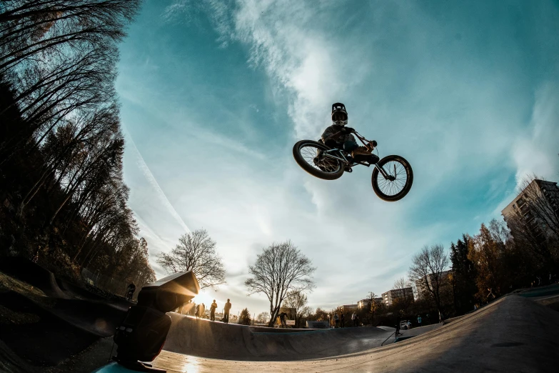 a man flying through the air while riding a bike, by Tobias Stimmer, pexels contest winner, realism, golden hour 8 k, skate park, eyes wide, winter season