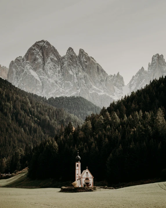 a church in the middle of a field with mountains in the background, unsplash contest winner, renaissance, pine trees in the background, dolomites in background, photo for vogue, view of forest