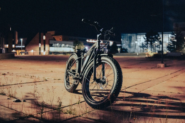 a bicycle parked in a parking lot at night, nordic noire, profile image, burly, super model-s 100