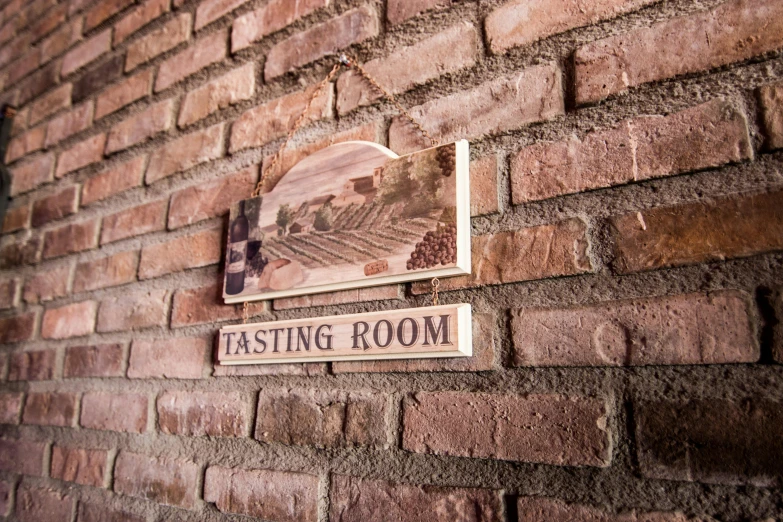 a sign that is on the side of a brick wall, wine label, a room, image, detail shot