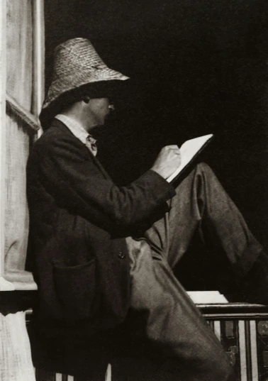 a black and white photo of a man reading a book, a charcoal drawing, by Algernon Talmage, with straw hat, jeffrey jones, edmund blair leighton, early 2 0 th century