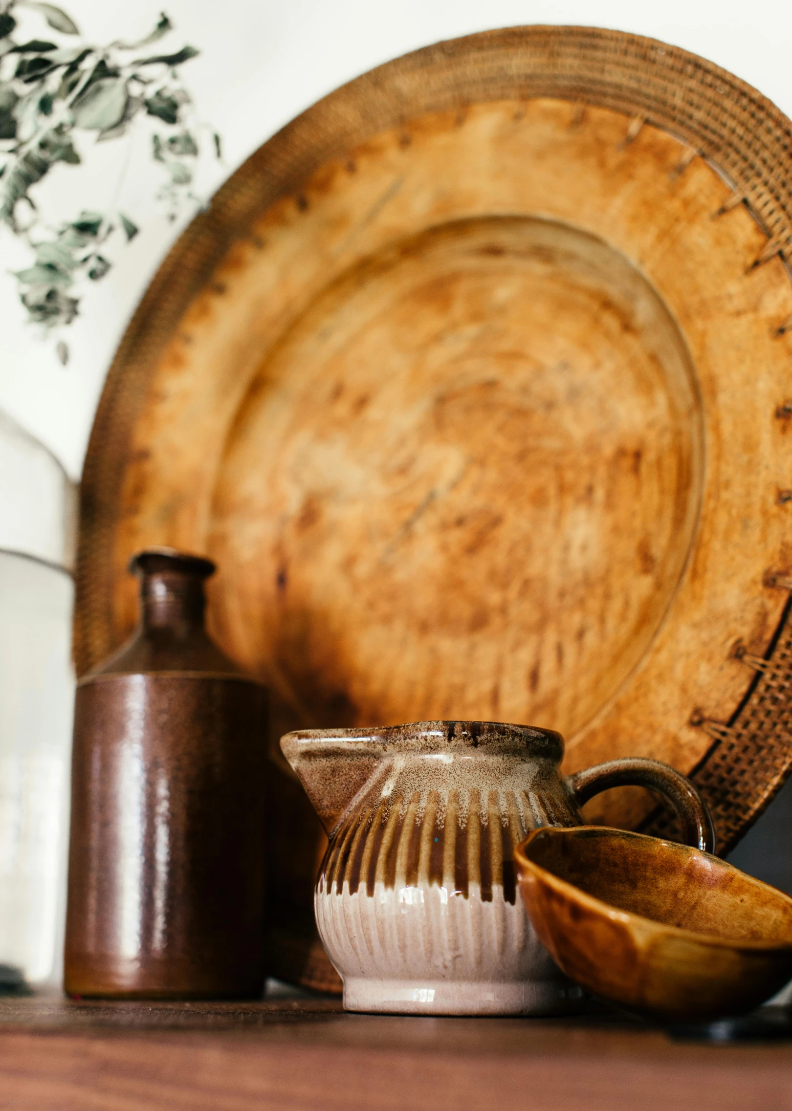 a wooden plate sitting on top of a wooden table, a still life, by Everett Warner, trending on unsplash, arts and crafts movement, large jars on shelves, brown and cream color scheme, ebay listing thumbnail, moroccan