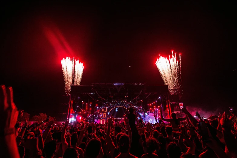 a crowd of people at a concert watching fireworks, unsplash contest winner, dance trance edm festival, blue and red lighting, profile image, ibiza