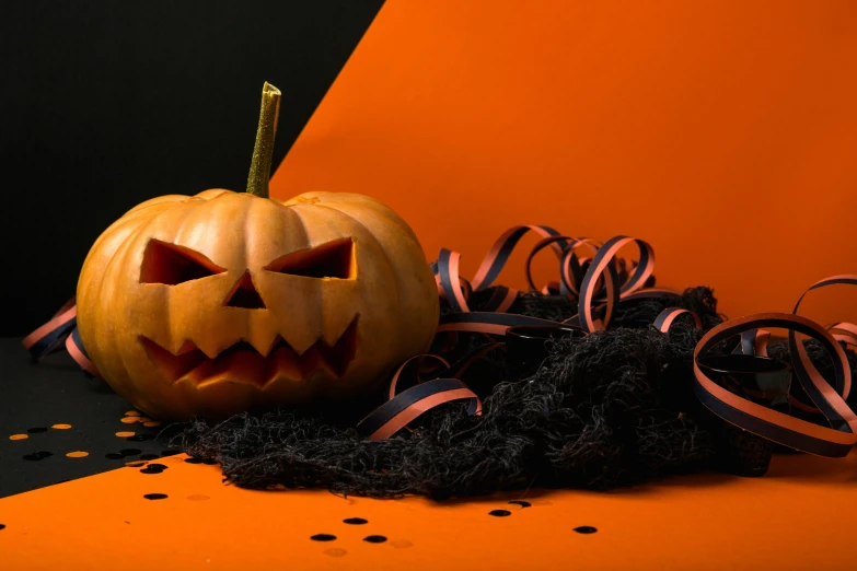 a halloween pumpkin sitting on top of a table, a portrait, pexels, background image, wrapped in black tentacles, hq print, rectangle