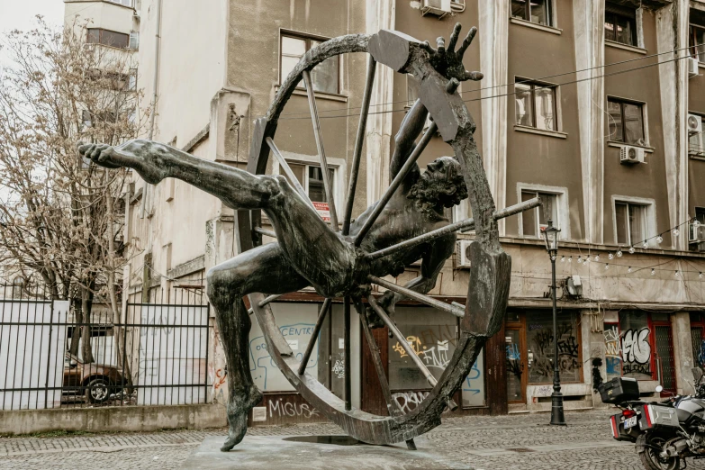 a statue of a man sitting on top of a wheel, inspired by Viktor Madarász, kinetic art, street art : 4 masterpiece, posuka demizu, 3 4 5 3 1, statue of the perfect woman