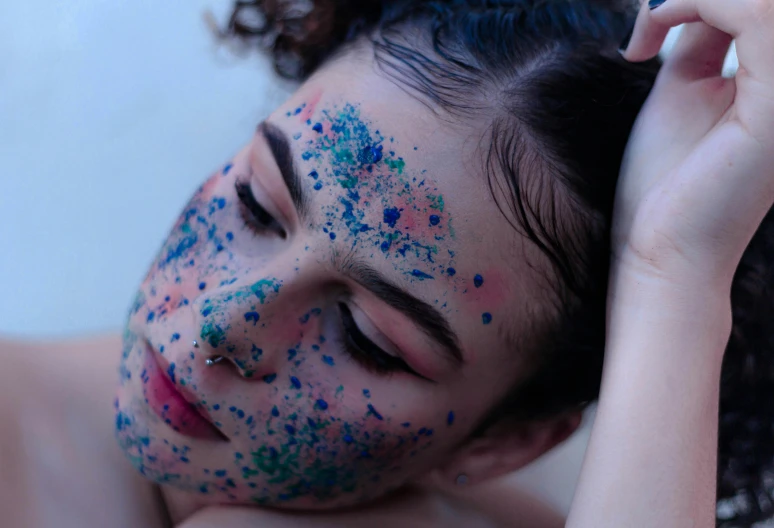 a woman with blue and green paint on her face, trending on pexels, pointillism, covered in sprinkles and crumbs, teenage girl, skincare, dreaming face