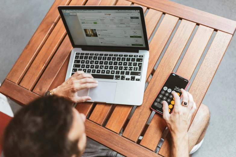 a man sitting at a table using a laptop computer, by Matthias Stom, trending on pexels, mobile learning app prototype, 9 9 designs, lawther sit at table playing dnd, taking from above