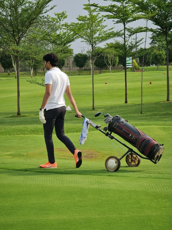 a man walking across a lush green golf course, instagram, happening, jakarta, attractive photo, annoyed, maintenance photo