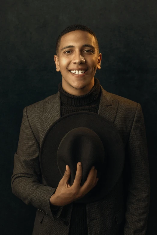 a man in a suit and hat posing for a picture, an album cover, inspired by Carlos Berlanga, pexels contest winner, portrait of barack obama, androgynous person, actor, elegant smiling pose