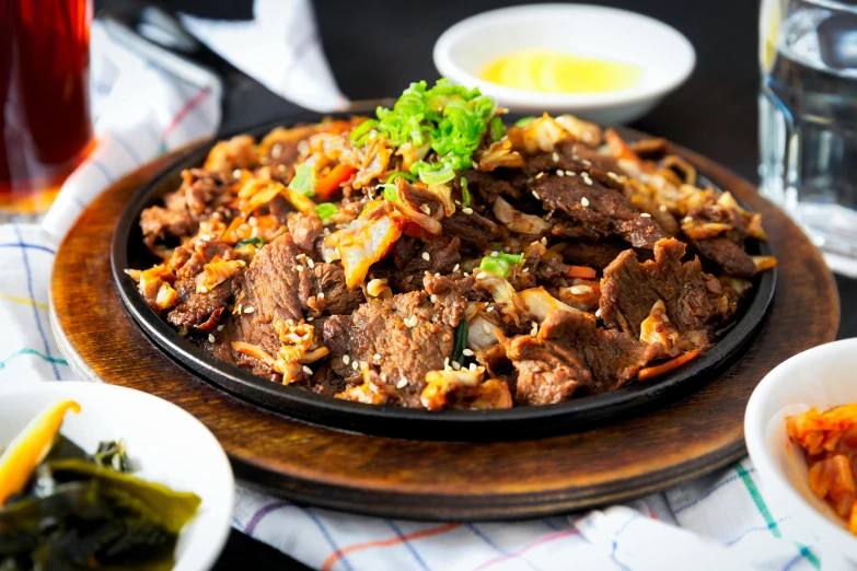 a close up of a plate of food on a table, unsplash, mingei, beefy, background image, naranbaatar ganbold, lomo saltado