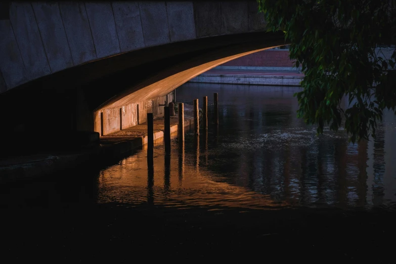 a bridge over a body of water at night, by Eglon van der Neer, unsplash contest winner, australian tonalism, sunlight reflected on the river, reflections in copper, under bridge, reflections. shady