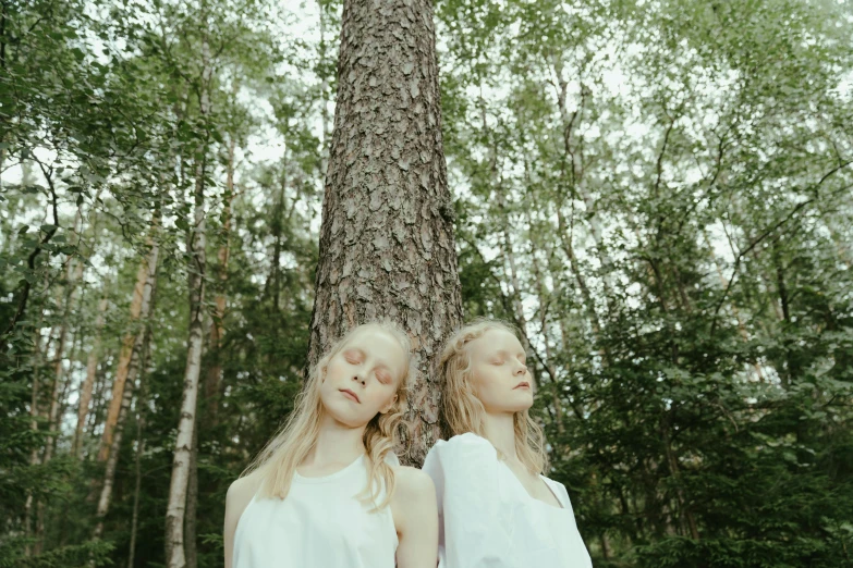 two girls standing next to a tree in a forest, an album cover, by Emma Andijewska, purism, portrait image, midsommar - t, white wood, ((trees))