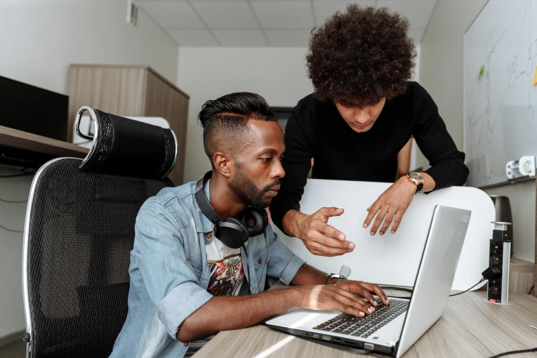 a couple of people sitting at a table with a laptop, trending on pexels, afro tech, creative coder with a computer, maintenance photo, thumbnail